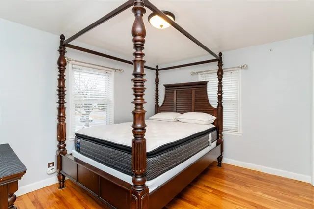a bed room with a bed and paintings on the wall