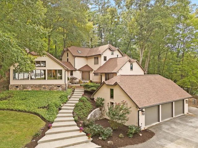 a aerial view of a house next to a yard with plants