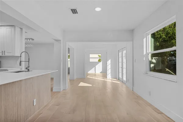 a view of empty room with wooden floor