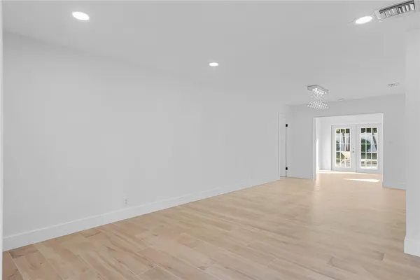 a view of a living room kitchen and a chandelier