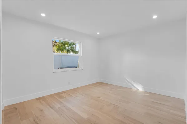 a view of a big room with window and ceiling fan