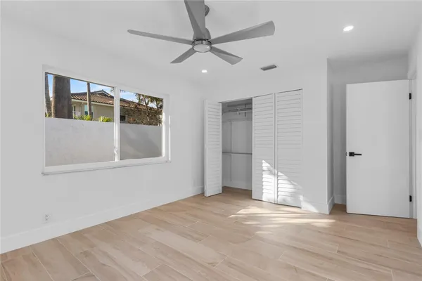 a view of a house with backyard and a tree