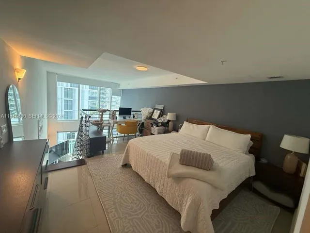 a bed room with a bed and a large window