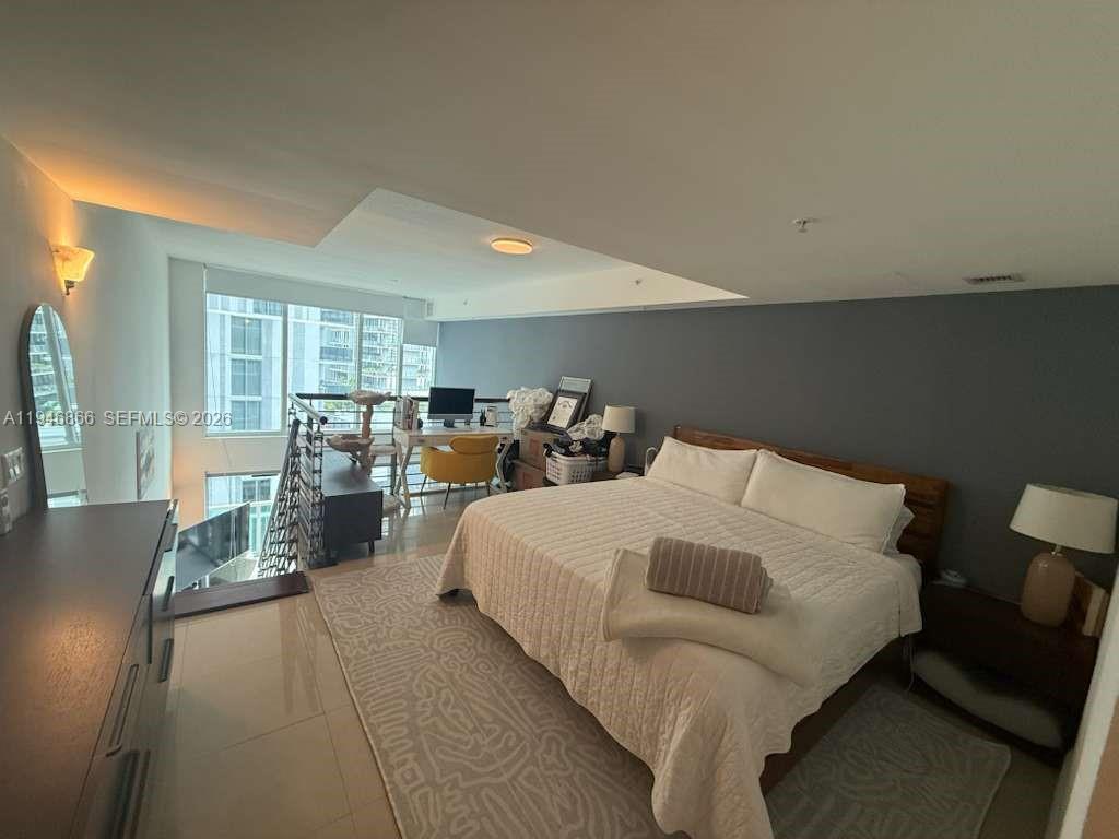 41 Southeast 5th Street, Unit 912 Miami, FL 33131 - Photo 11 of 23 a bed room with a bed and a large window