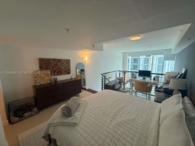 a bed room with a bed window and a couch