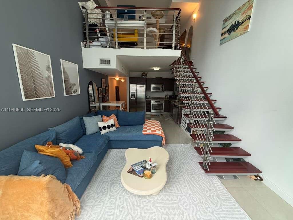 41 Southeast 5th Street, Unit 912 Miami, FL 33131 - Photo 4 of 23 a living room with furniture and wooden floor