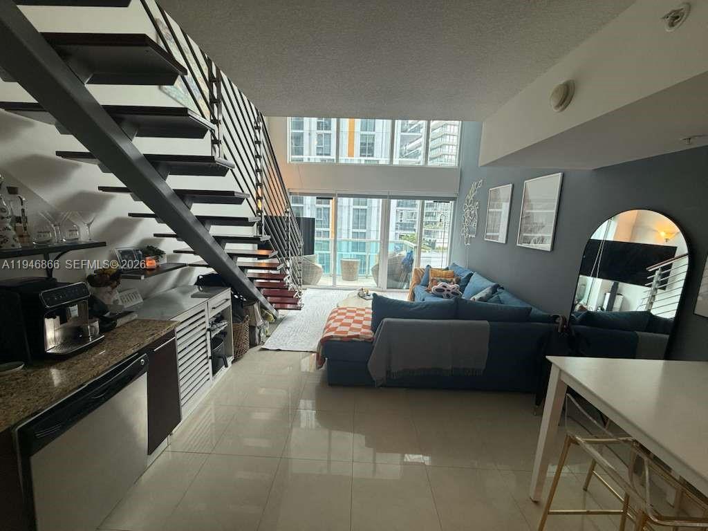 41 Southeast 5th Street, Unit 912 Miami, FL 33131 - Photo 6 of 23 a living room with furniture and a wooden floor