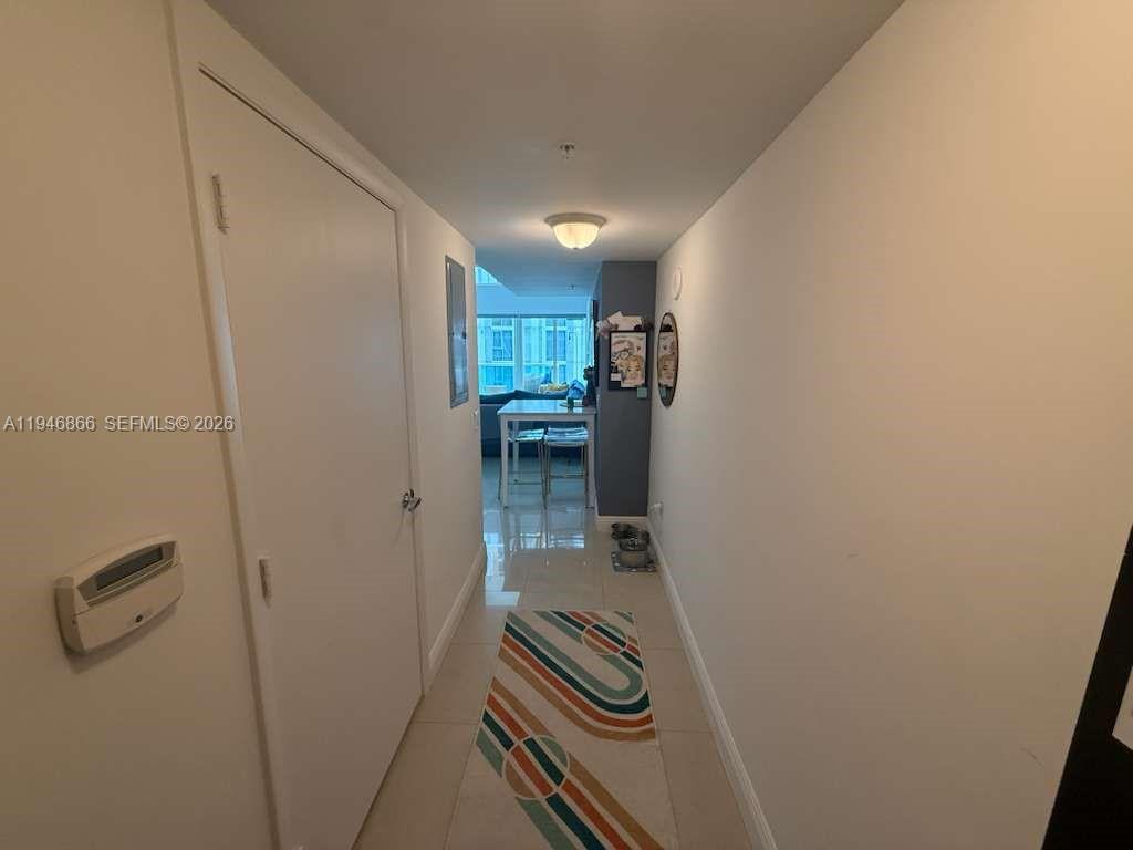 41 Southeast 5th Street, Unit 912 Miami, FL 33131 - Photo 9 of 23 a view of a storage & utility room with a washer dryer