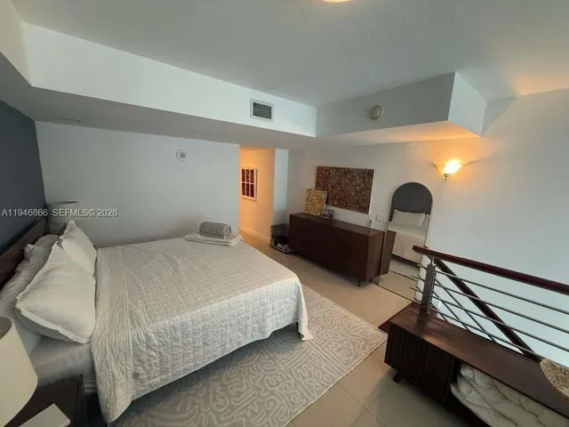 a bedroom with bed and window