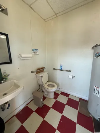 a bathroom with a black and white checkered floor