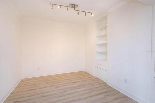 a view of a room with wooden floor