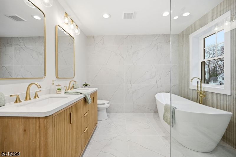 41 Orchard Road Florham Park, NJ 07932 - Photo 19 of 34 a bathroom with a double vanity sink toilet and a mirror