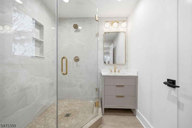 41 Orchard Road Florham Park, NJ 07932 - Photo 30 of 34 a bathroom with a shower sink and mirror