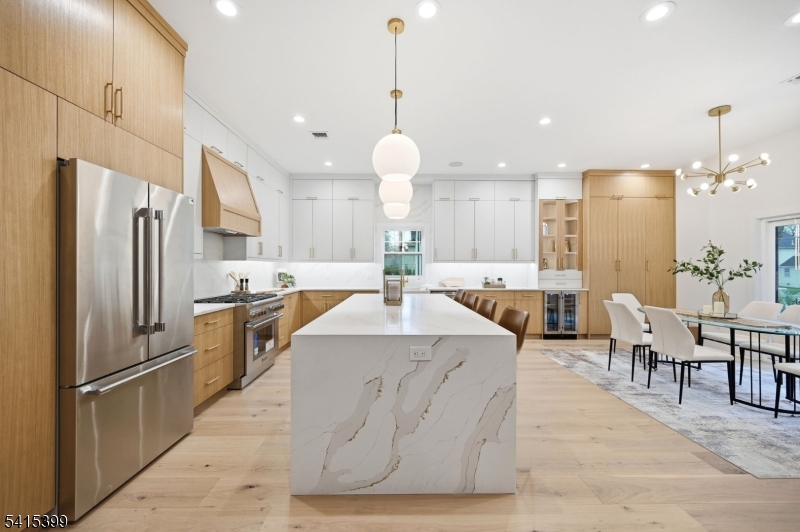 41 Orchard Road Florham Park, NJ 07932 - Photo 6 of 34 a kitchen with stainless steel appliances kitchen island granite countertop a refrigerator a oven a sink and a dining table with wooden floor