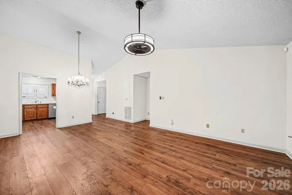 a view of a room with wooden floor and windows