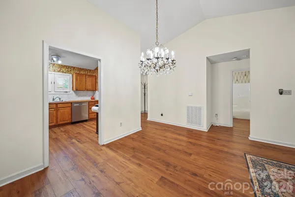 a view of a room with wooden floor and cabinet