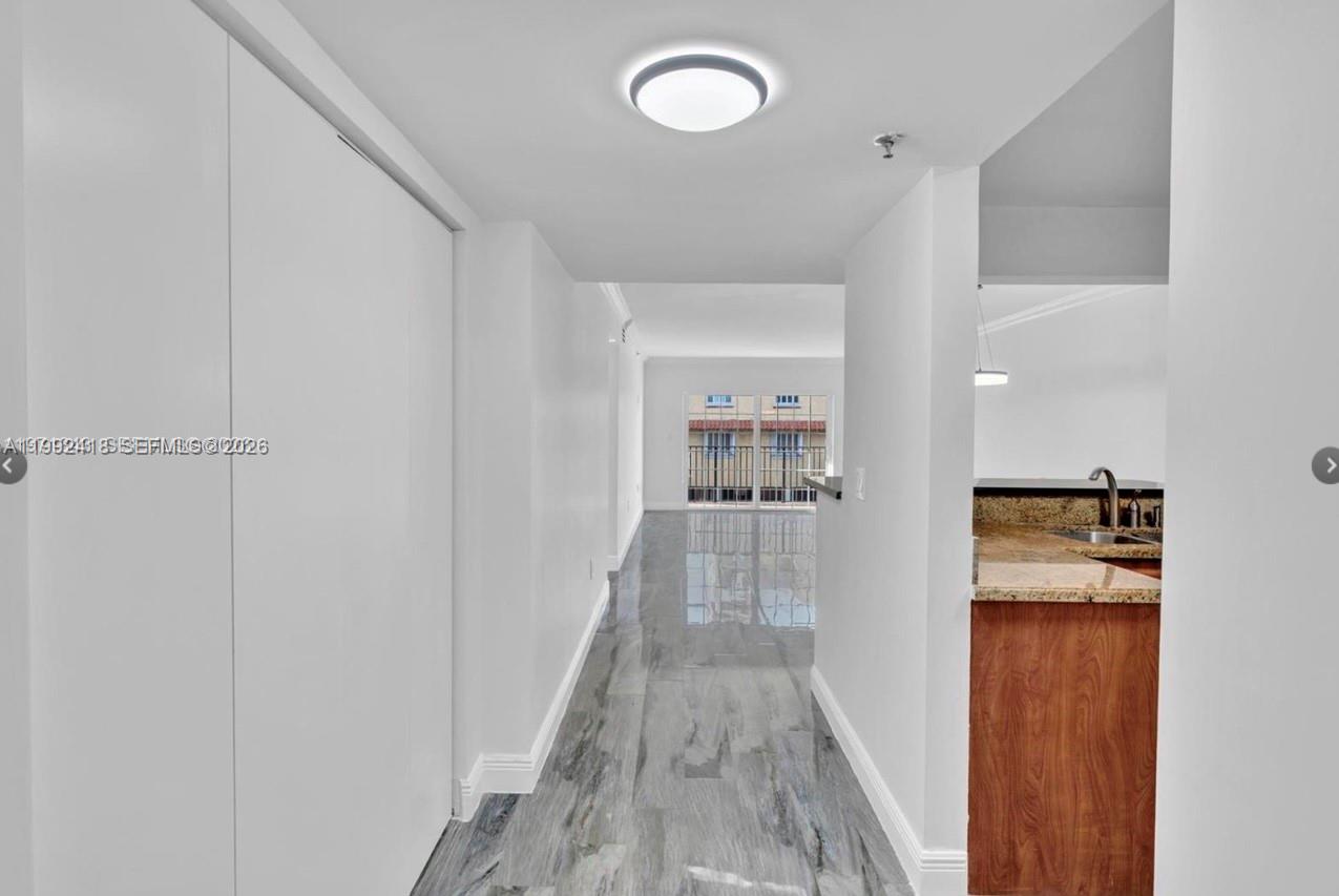 8900 Collins Avenue, Unit 304 Surfside, FL 33154 - Photo 11 of 18 a view of a room with wooden floor