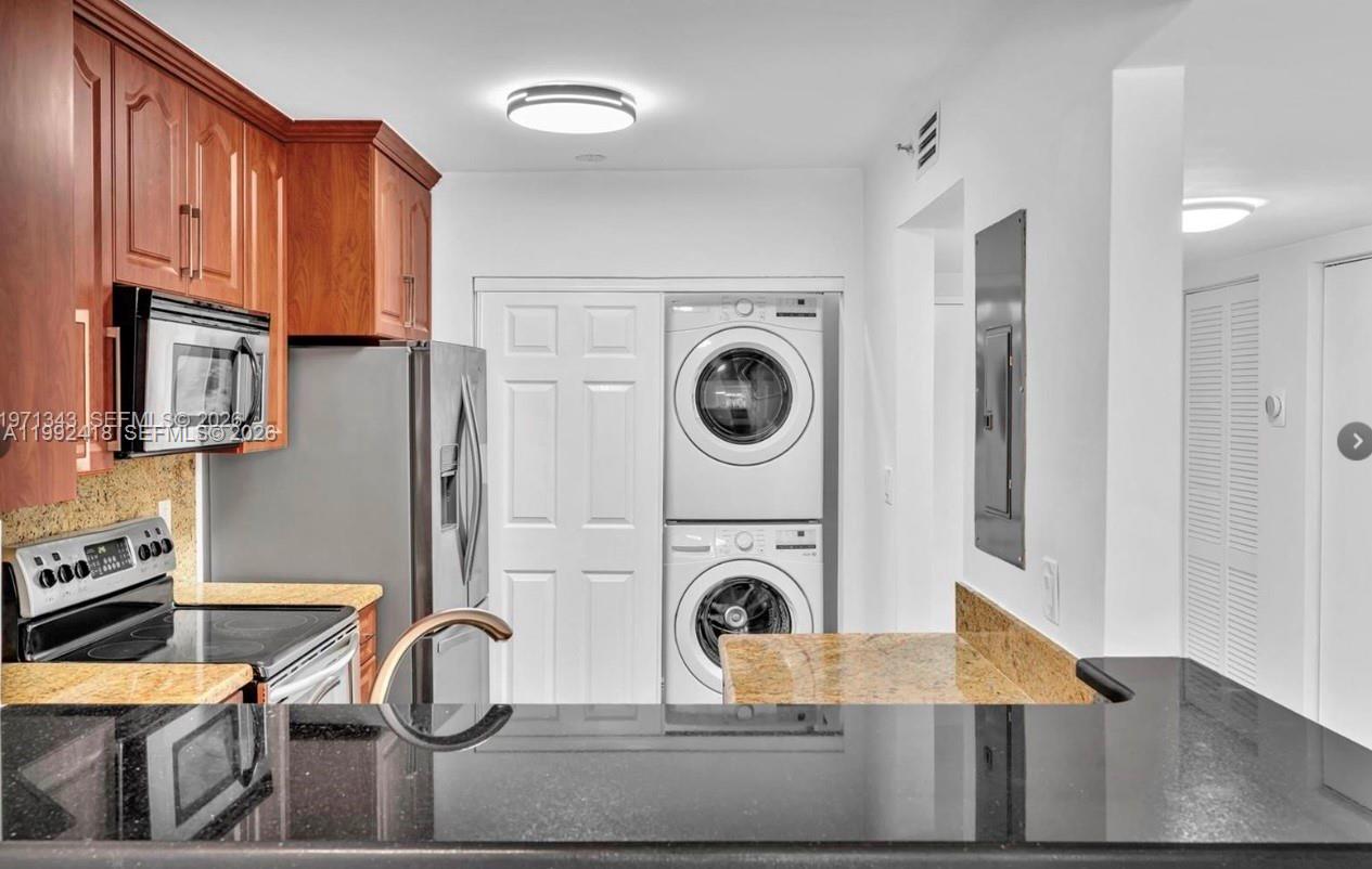 8900 Collins Avenue, Unit 304 Surfside, FL 33154 - Photo 14 of 18 a view of a kitchen with washer and dryer