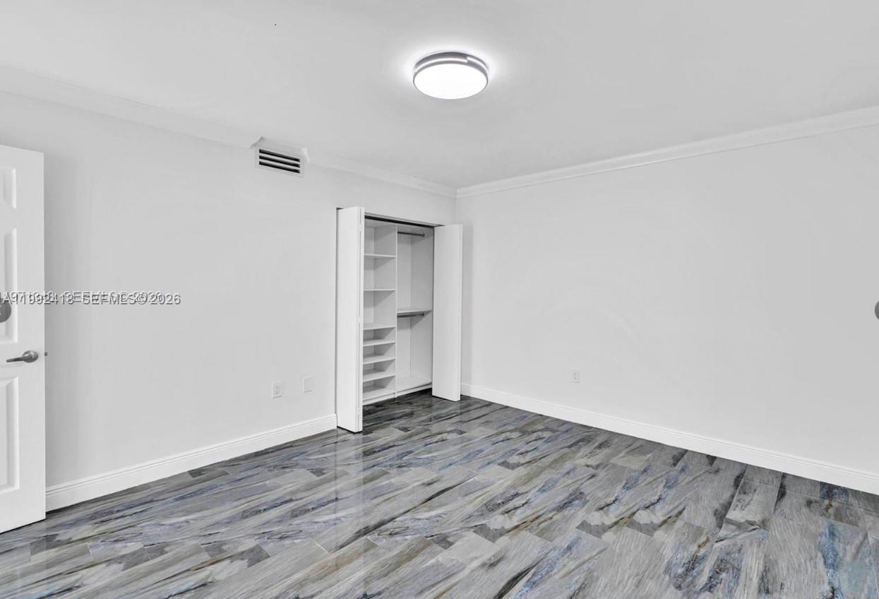 8900 Collins Avenue, Unit 304 Surfside, FL 33154 - Photo 2 of 18 wooden floor in an empty room