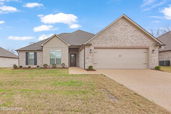 a view of a house with a yard and garage
