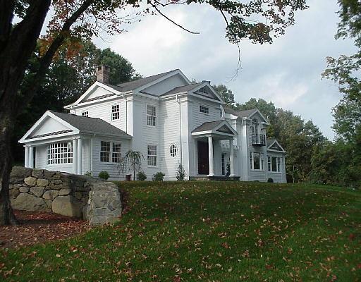 16 Olmstead Hill Road Wilton, CT 06897 - Photo 1 of 1 a front view of a house with a garden
