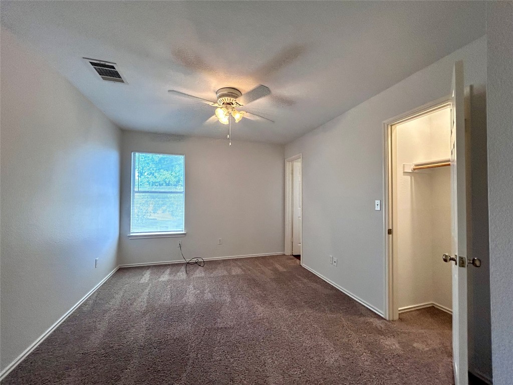 12307 Abney Drive Austin, TX 78729 - Photo 11 of 18 an empty room with windows and fan