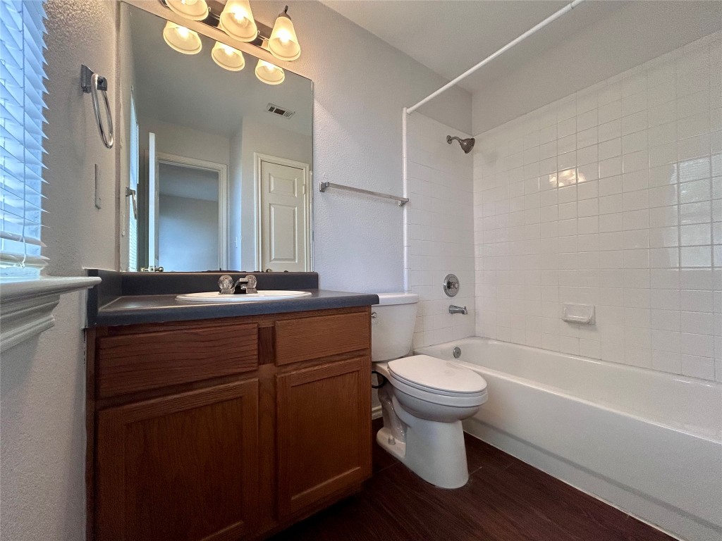 12307 Abney Drive Austin, TX 78729 - Photo 12 of 18 a bathroom with a sink toilet a mirror and shower