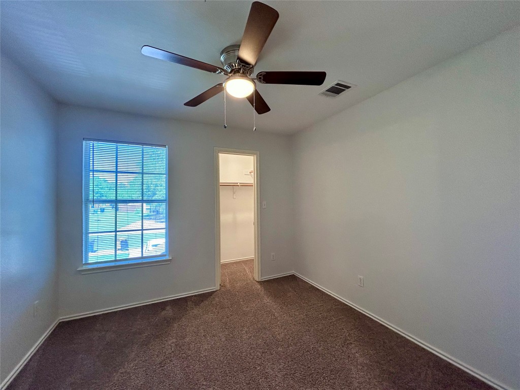 12307 Abney Drive Austin, TX 78729 - Photo 15 of 18 an empty room with windows and fan