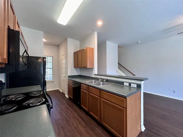 a view of a kitchen and dining room with wooden floor