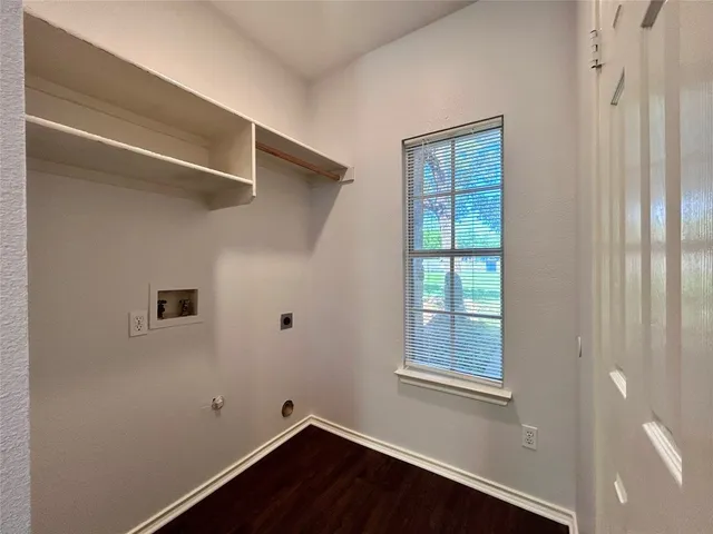 a kitchen with wooden floor and a stove