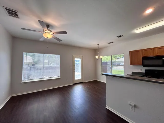 a view of a room with wooden floor and windows