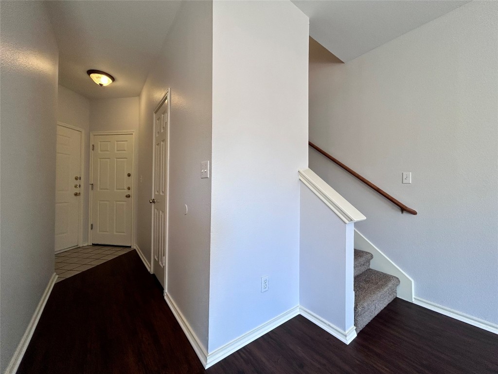 12307 Abney Drive Austin, TX 78729 - Photo 7 of 18 a view of hallway with stairs and wooden floor