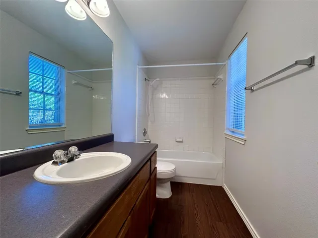 a bathroom with a sink a toilet a shower and a mirror