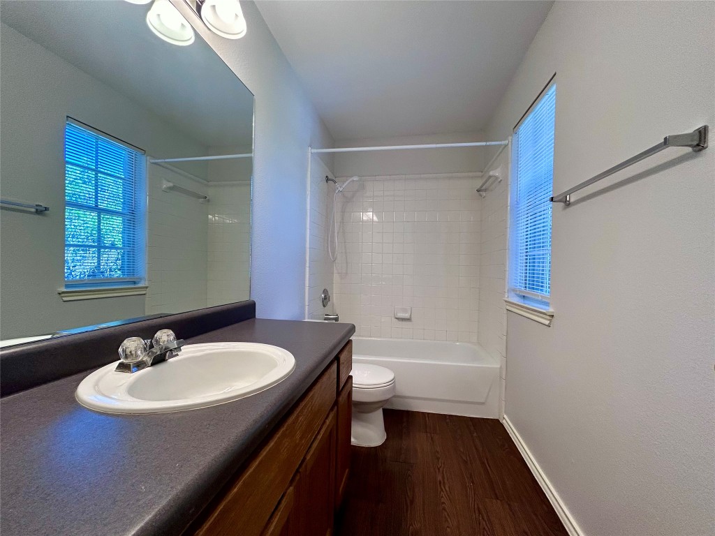 12307 Abney Drive Austin, TX 78729 - Photo 9 of 18 a bathroom with a sink a toilet a shower and a mirror