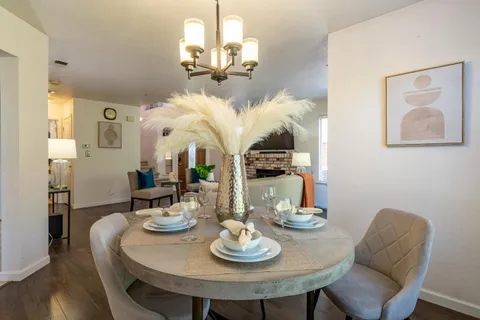 a view of a dining room with furniture wooden floor and chandelier