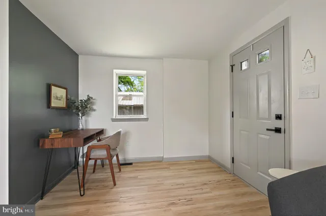 a view of a livingroom with wooden floor and a window
