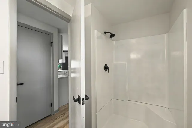 a bathroom with a glass shower door