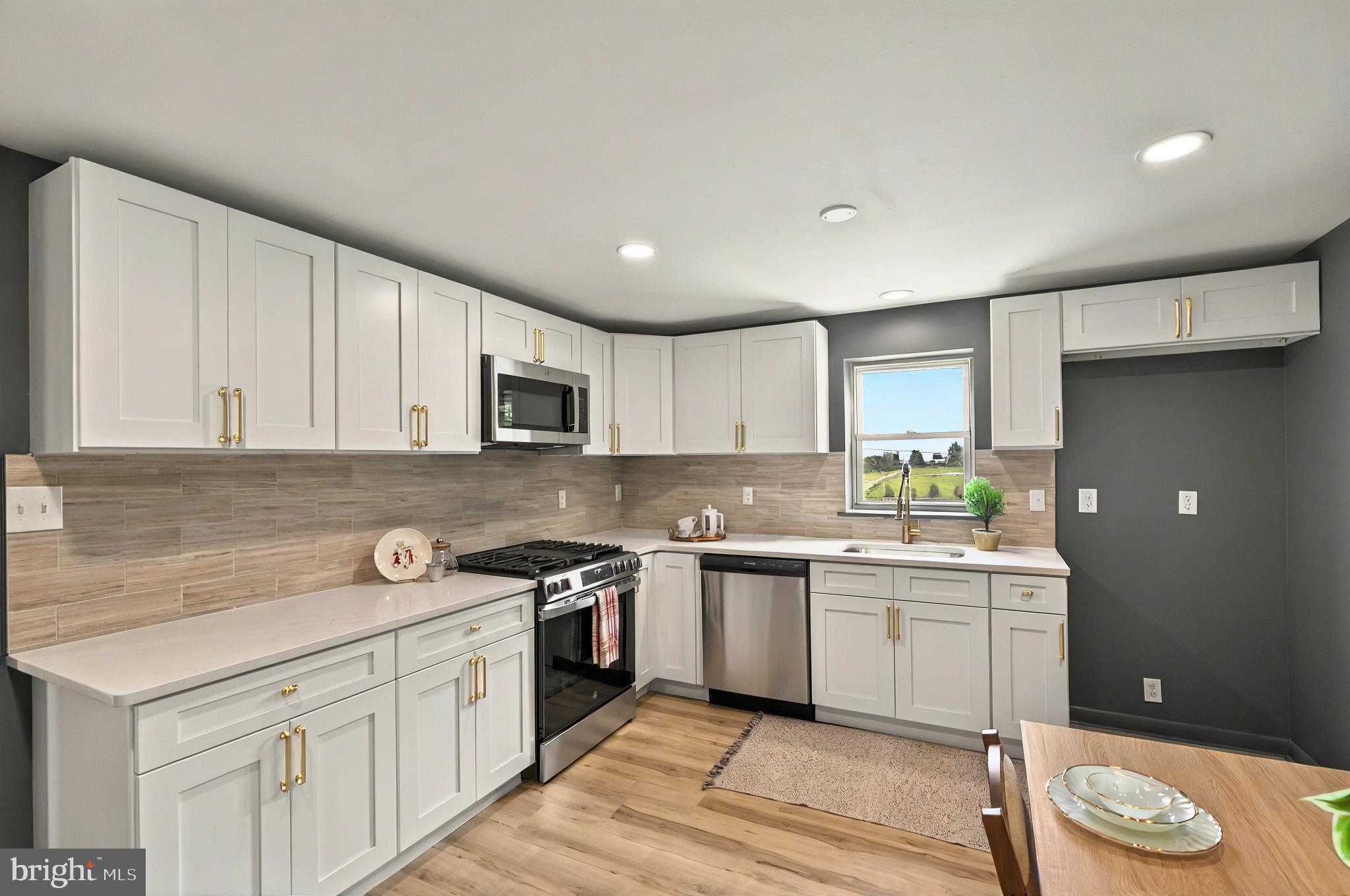 222 Old Racetrack Road Parkesburg, PA 19365 - Photo 17 of 37 a kitchen with a sink cabinets and wooden floor