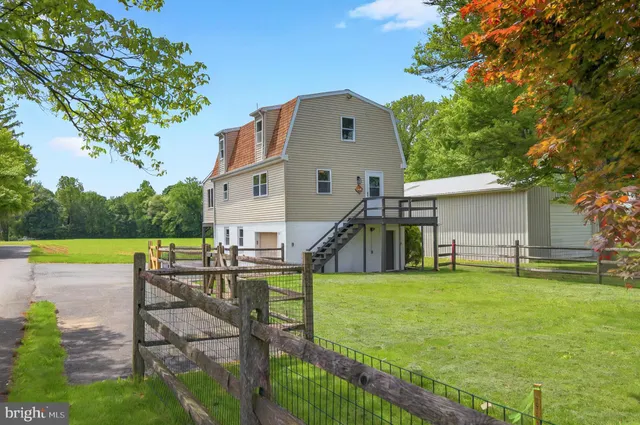 a house view with swimming pool and garden space