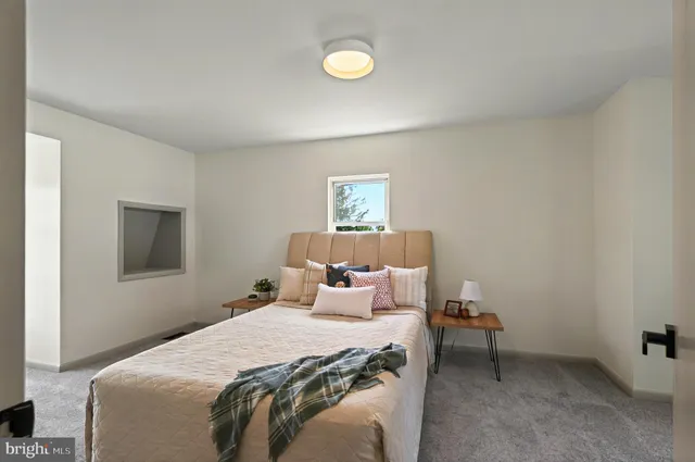 a bedroom with a bed and lamp