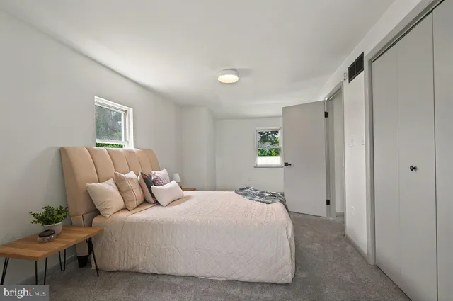 a bedroom with a bed and a couch