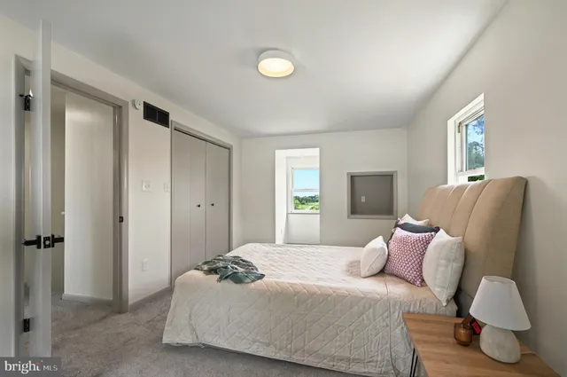 a bedroom with a bed and window