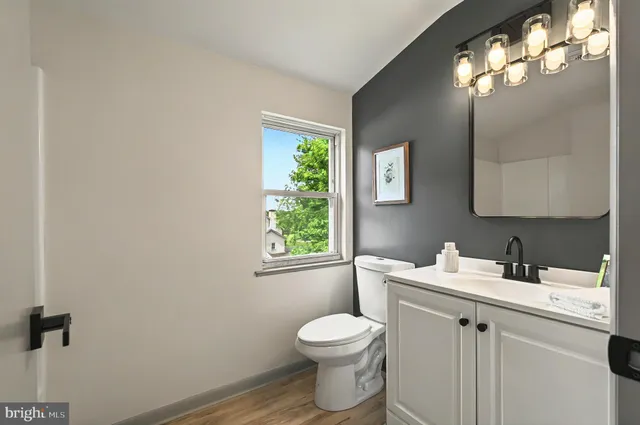 a bathroom with a toilet sink and mirror