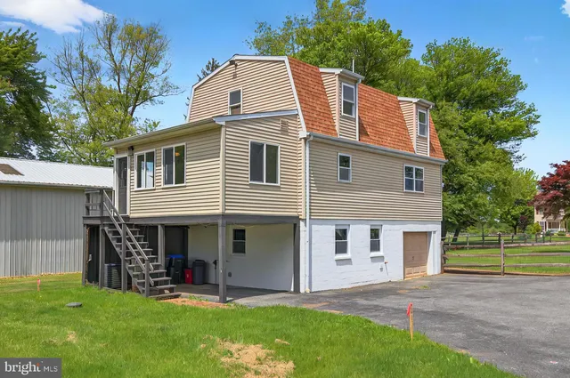 a view of a house with a yard and sitting area