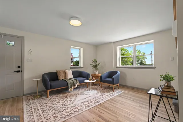 a living room with furniture and wooden floor
