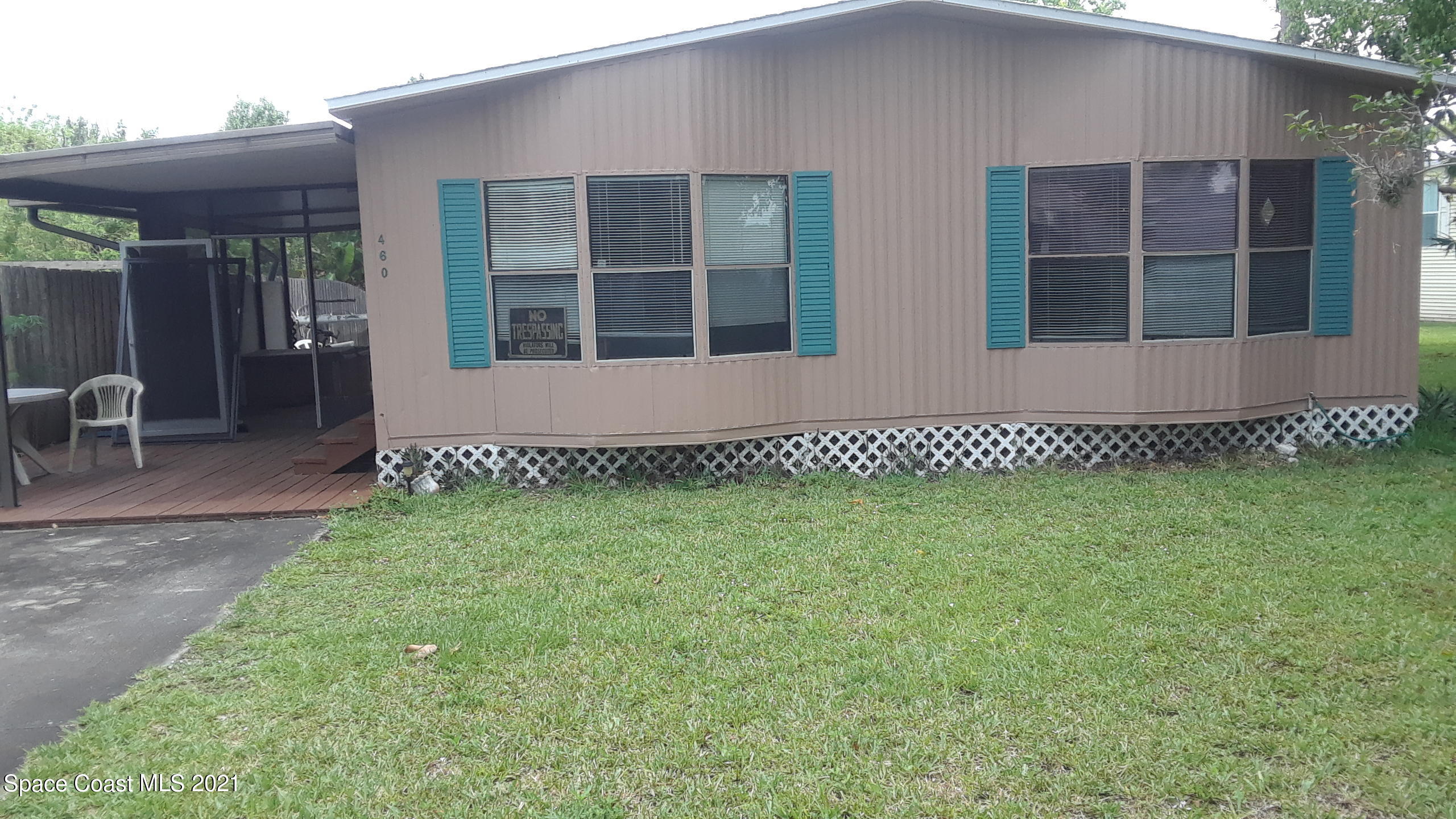 460 Baker Road Merritt Island, FL 32953 - Photo 1 of 6 a front view of a house with a garden