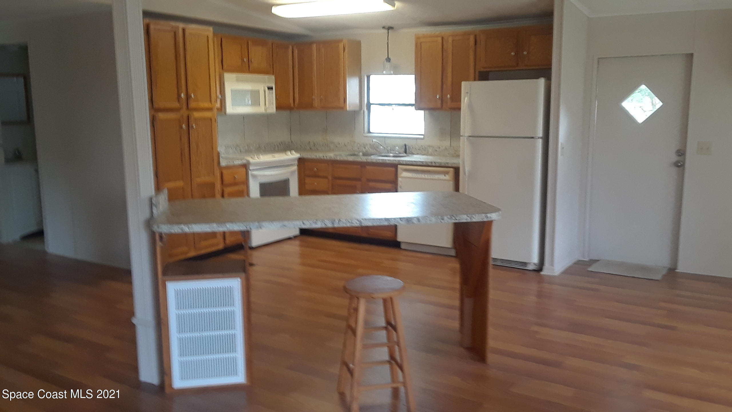 460 Baker Road Merritt Island, FL 32953 - Photo 2 of 6 a kitchen with stainless steel appliances a refrigerator and a cabinets
