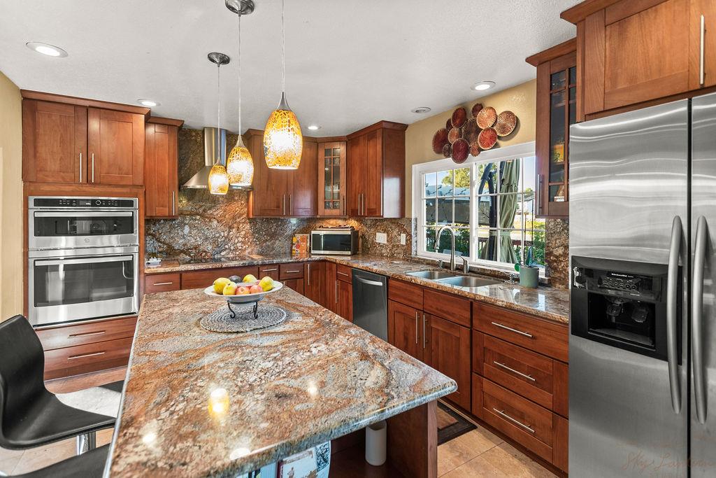35664 Lundy Drive Newark, CA 94560 - Photo 12 of 34 a kitchen with stainless steel appliances granite countertop a sink a stove and a refrigerator