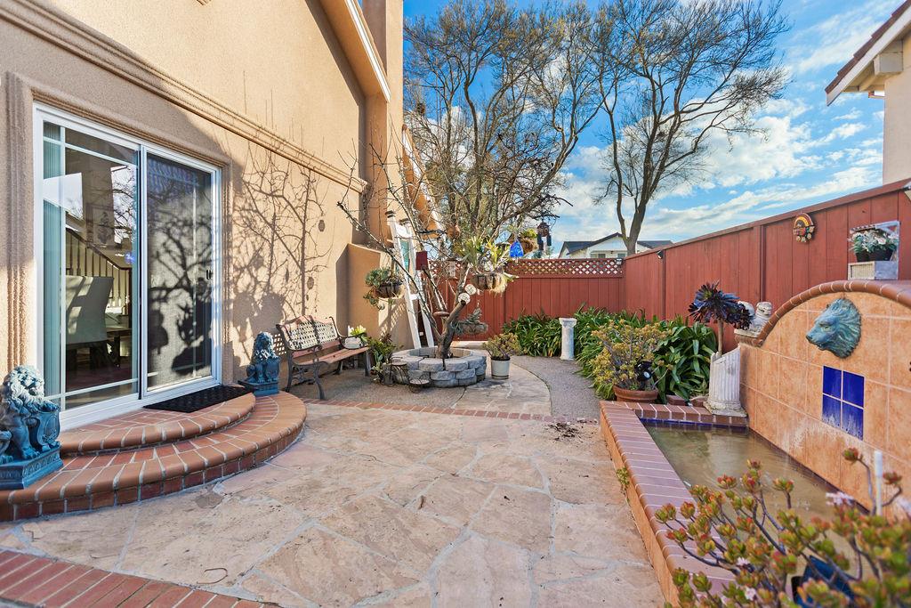 35664 Lundy Drive Newark, CA 94560 - Photo 31 of 34 a view of a brick house with potted plants and a patio