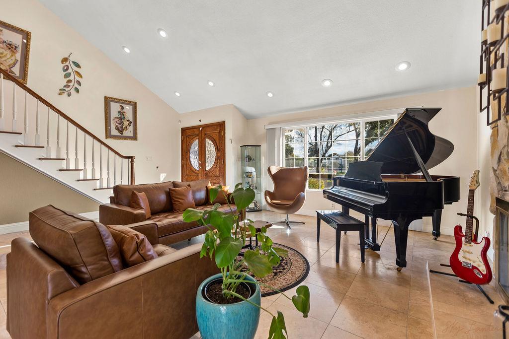 35664 Lundy Drive Newark, CA 94560 - Photo 7 of 34 a living room with furniture a rug and a piano